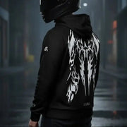 Motorcyclist wearing the LUMA Rider hoodie on a rainy city street, back graphic visible