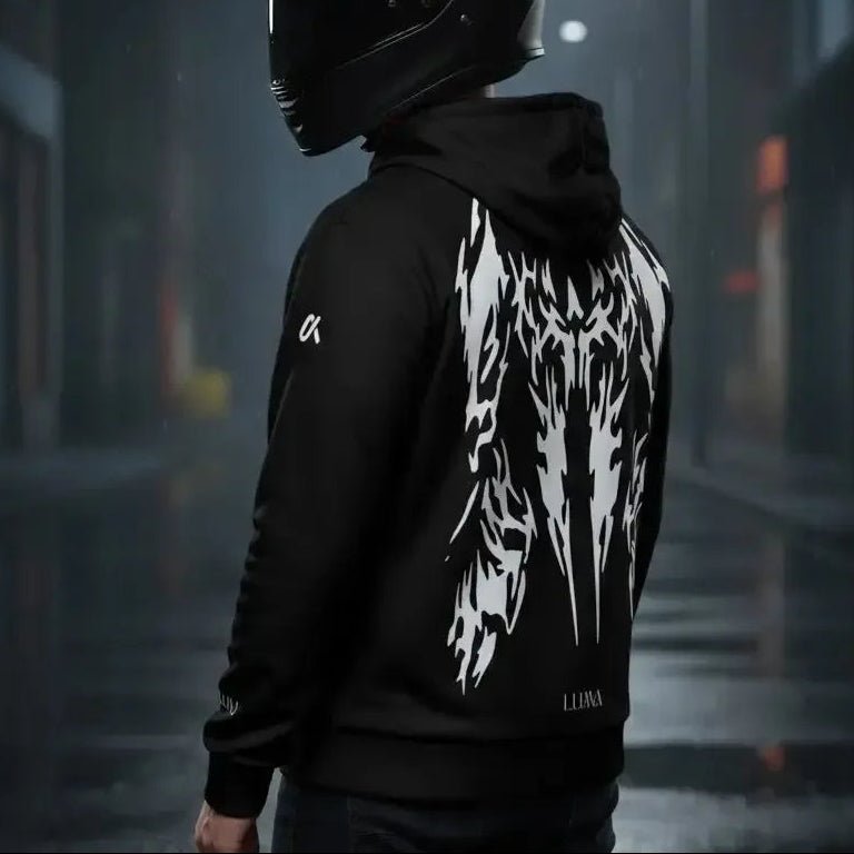 Motorcyclist wearing the LUMA Rider hoodie on a rainy city street, back graphic visible