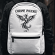 Close-up of the LUMA Chrome Phoenix backpack's tattoo-style phoenix graphic print worn on a person's back
