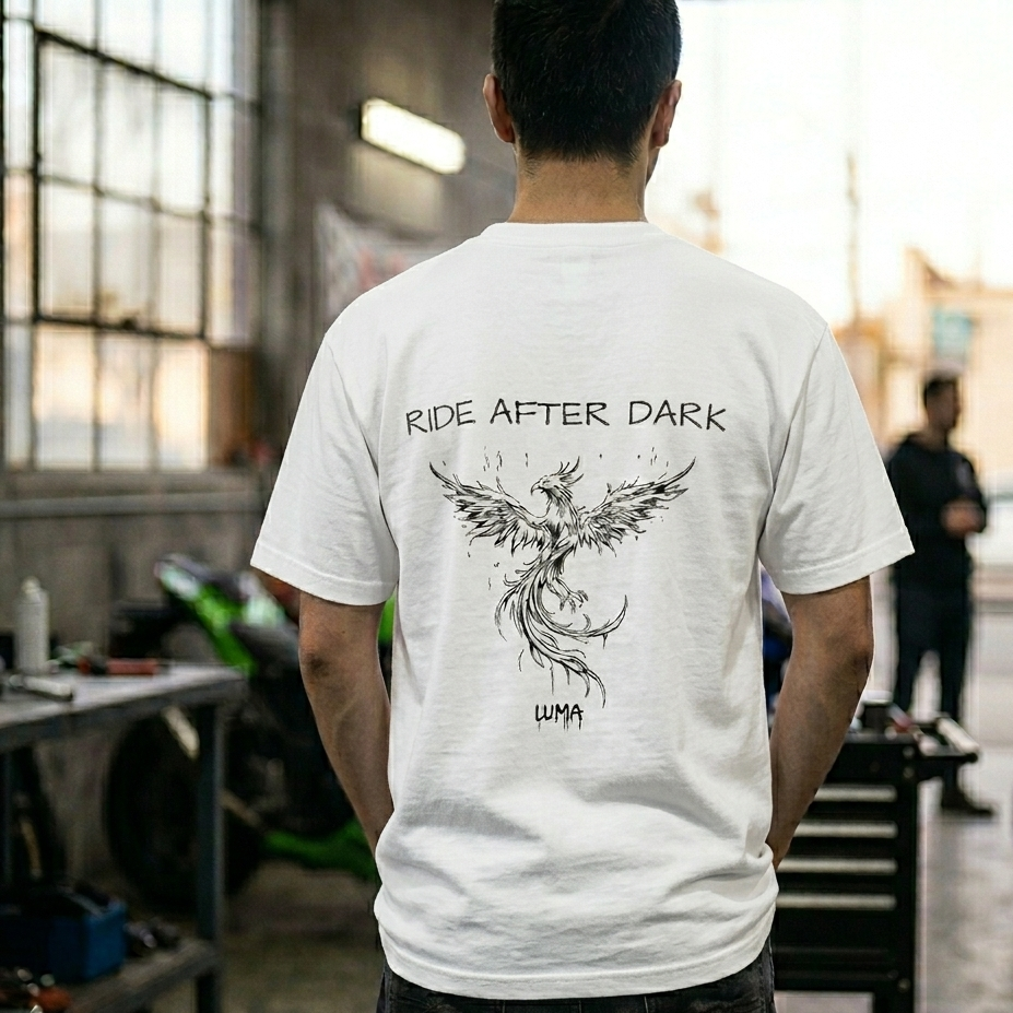 Person wearing a white t-shirt with 'Ride After Dark' design 