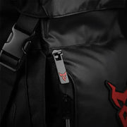 Close-up of the LUMA MotoPack Pro's buckle, zipper pull, and red logo badge