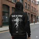 Man wearing the LUMA Pulse of Chaos hoodie on a city street, back graphic and text visible