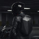 Motorcyclist in leather jacket and helmet wearing the LUMA CarbonRide waterproof backpack, rear view