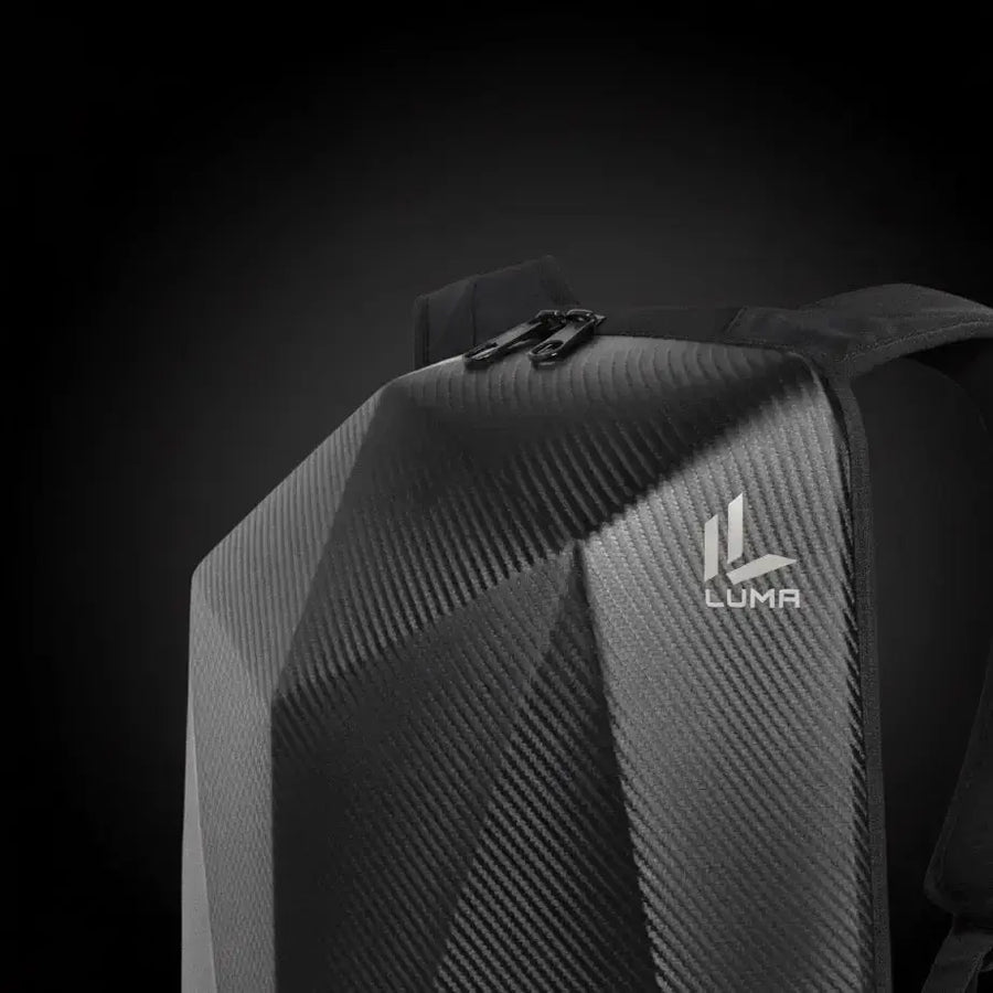 Close-up of the LUMA CarbonRide backpack's carbon-fiber top panel, zipper, and logo