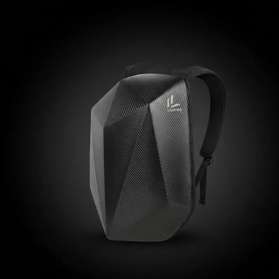 LUMA CarbonRide backpack front view with reflective logo on dark background
