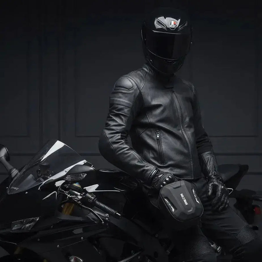 Motorcyclist in leather jacket and helmet with the LUMA Leg Bag strapped to his thigh, seated on a sportbike