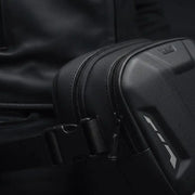 Close-up of the LUMA Leg Bag's zippers, buckle strap, and logo detail