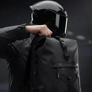 Close-up of a rider lifting the LUMA AquaRider backpack onto their shoulder