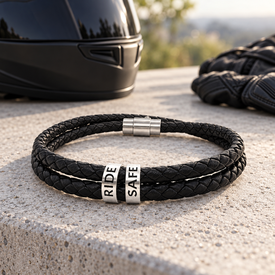 Engraved leather biker bracelet with RIDE SAFE beads beside a black motorcycle helmet and riding gloves