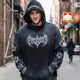 Man wearing the LUMA Gothic Washed hoodie in black, front gothic graphic visible, city street