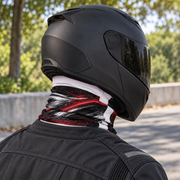 Rear view of a rider in a matte black full-face helmet wearing a UPF 50+ neck gaiter