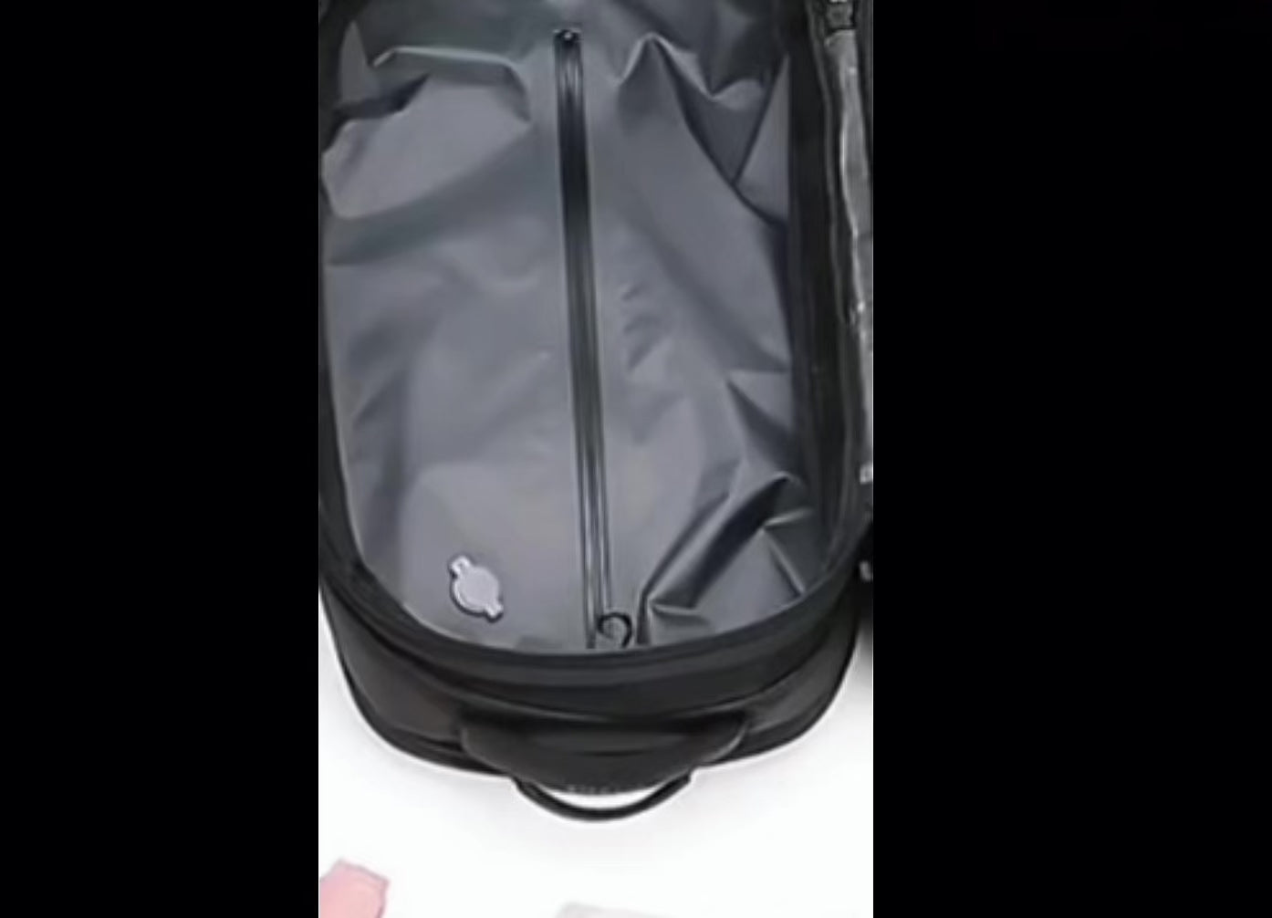 Interior view of the LUMA Expand Pro backpack revealing the vacuum-compression compartment for expanded storage capacity.
