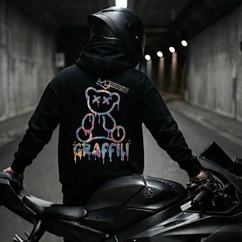 Motorcycle rider in a LUMA Graffiti Bear hoodie, showcasing bold streetwear style for American sportbike riders.
